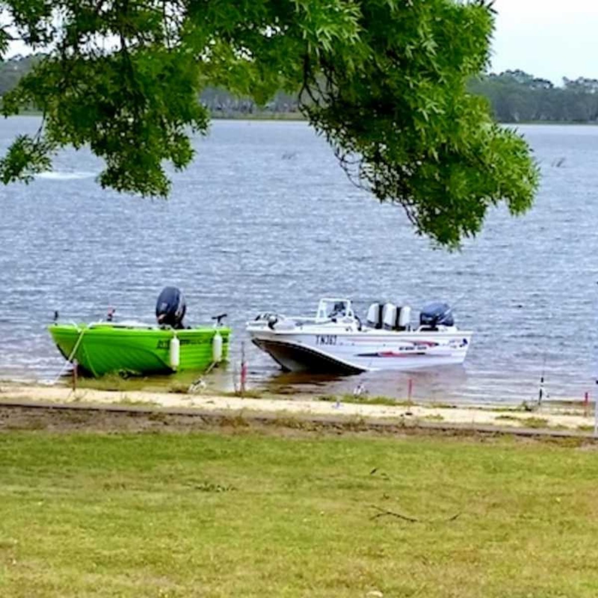 edenhope lakeside tourist park lake with two boats moored