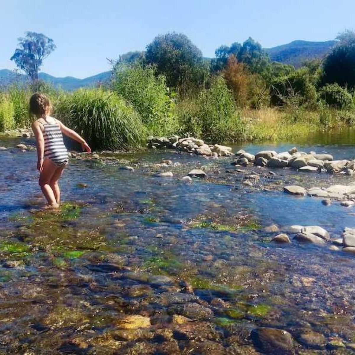 khancoban lakeside caravan park creek with young child playing